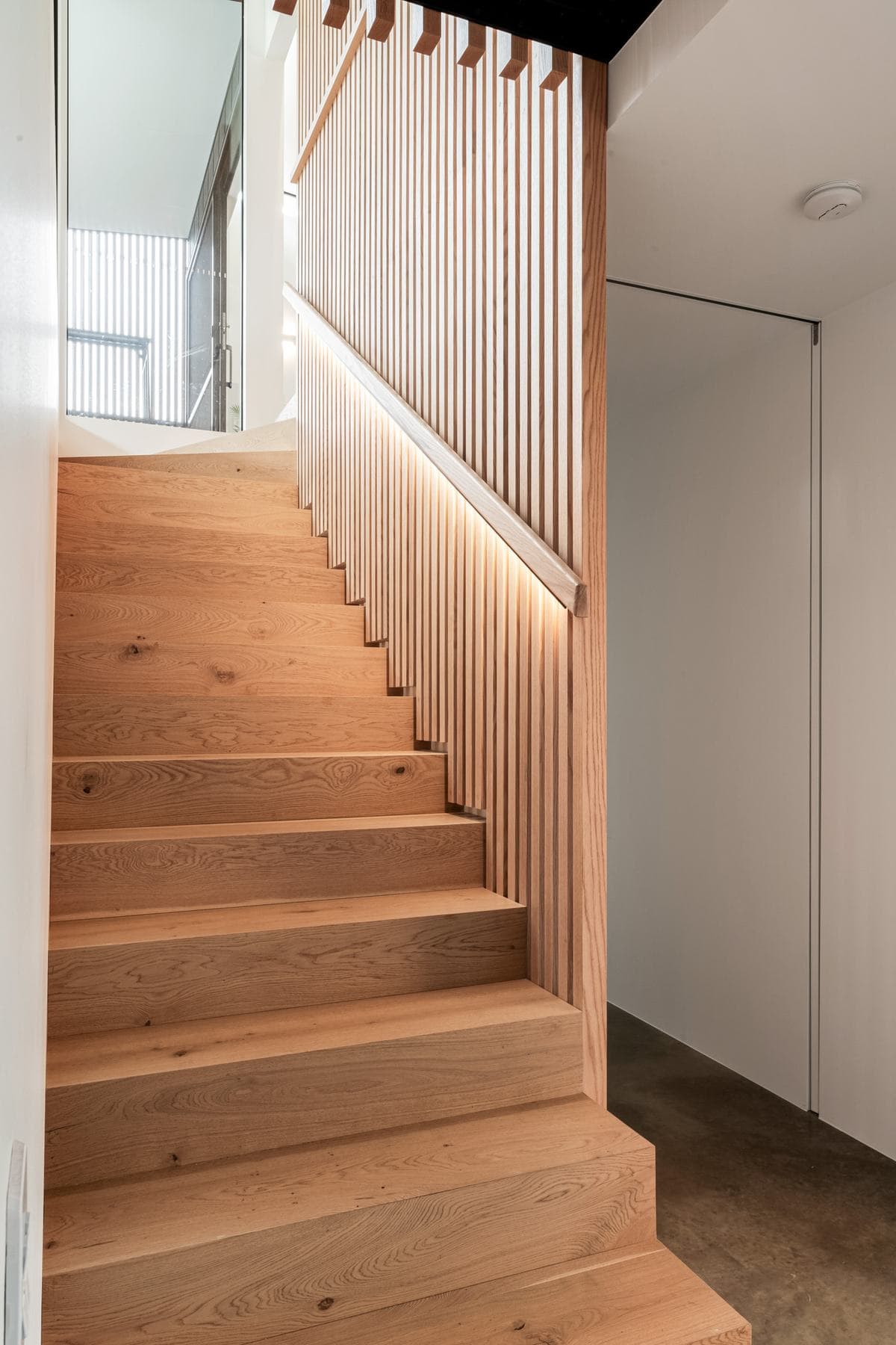 Oak staircase with timber battens in a custom home built by Perrem