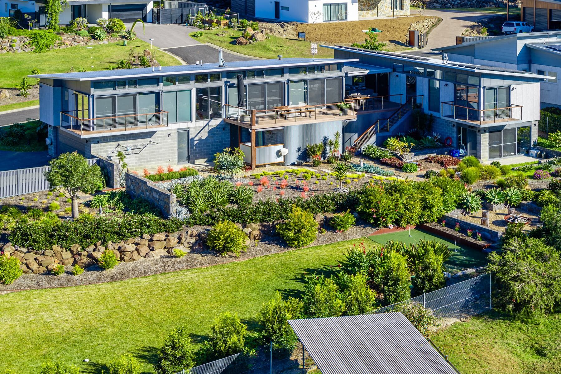Sustainable home set into a landscaped coastal block
