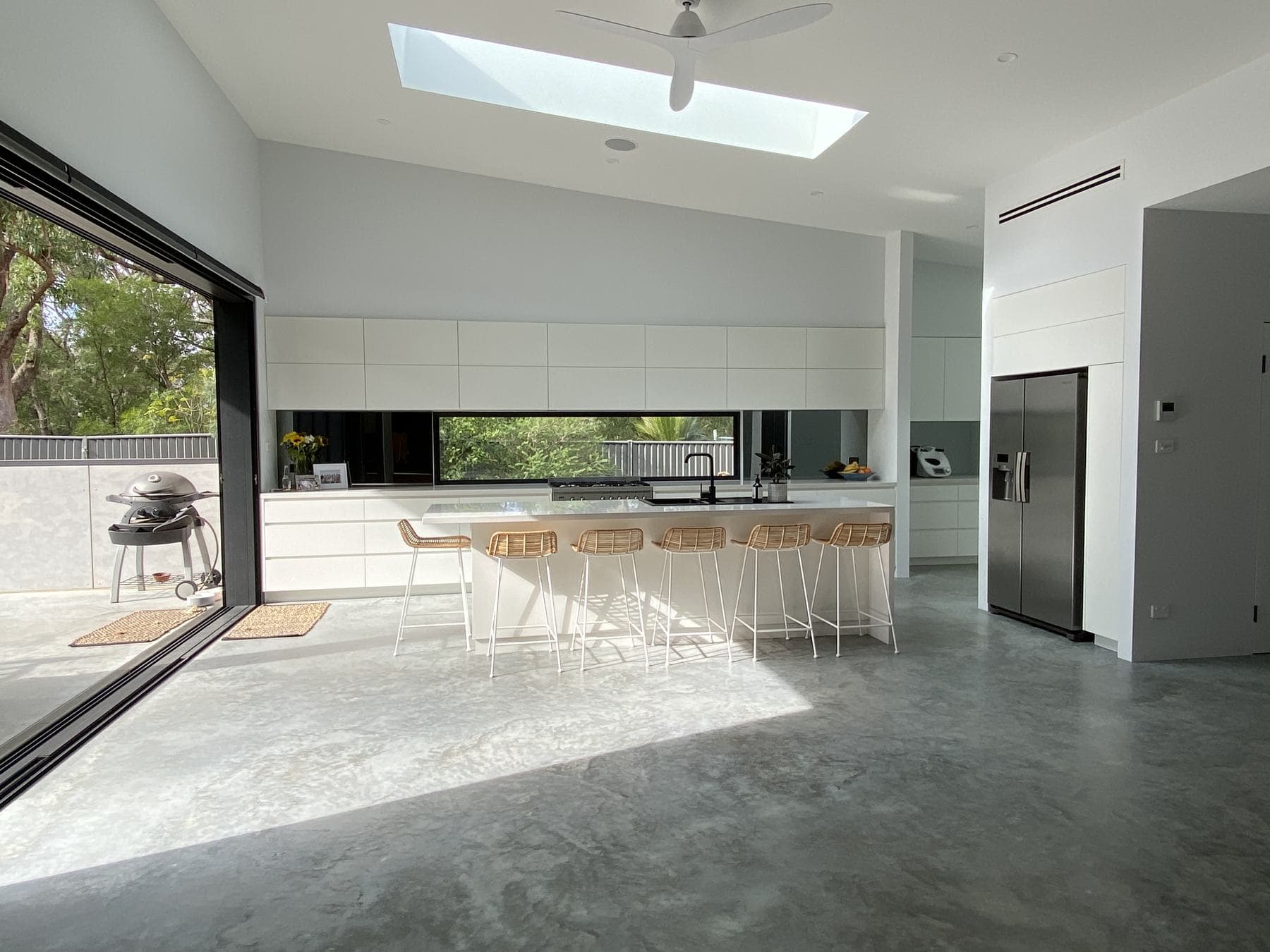 Polished concrete floor and open kitchen with a large sliding door
